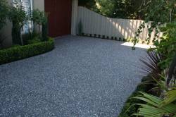 Box hedges, cream fence and aggregate concrete driveway