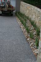 Gorgeous Aggregate mix with large pebbles and stone fence